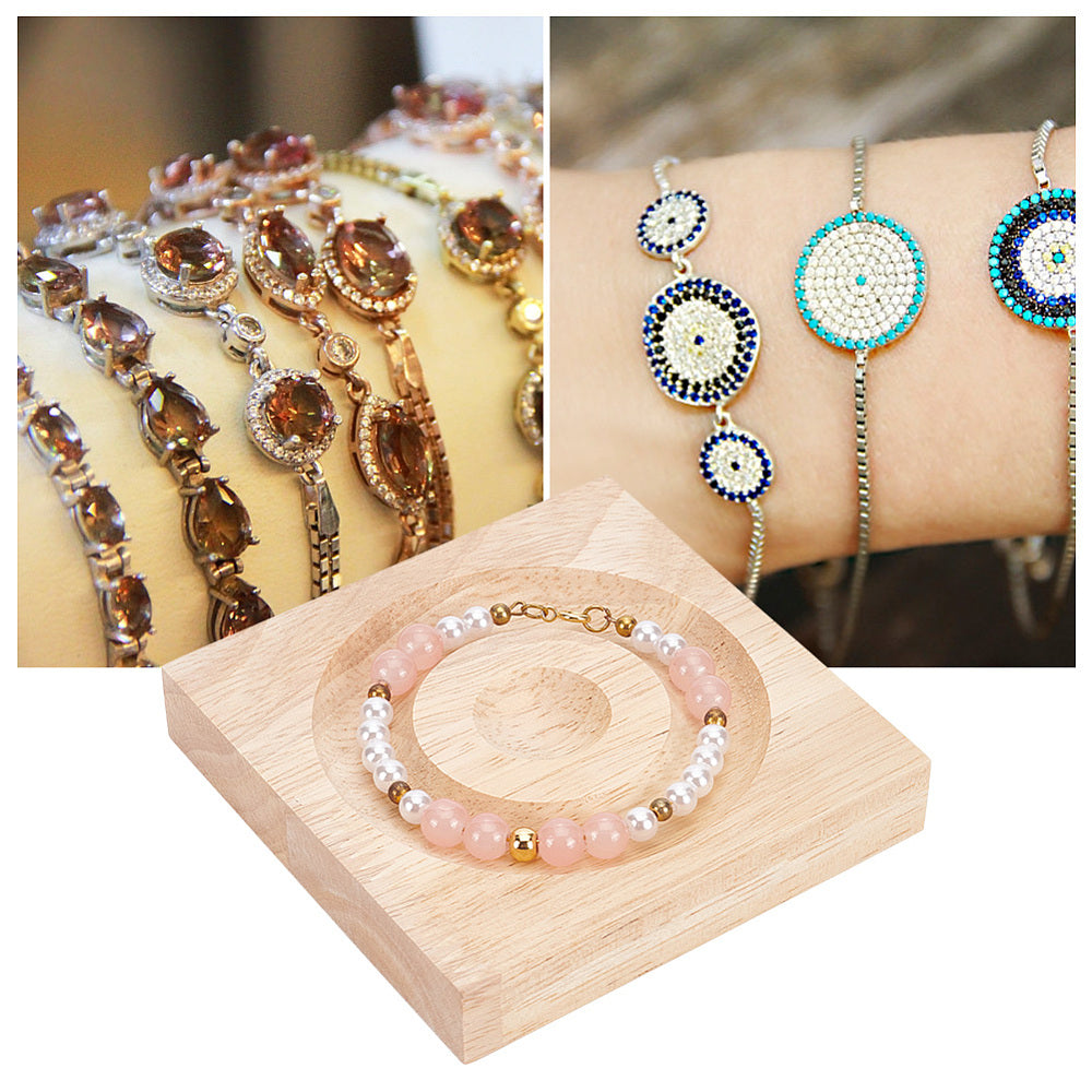 Wood jewelry display tray with pink and clear beaded bracelet on round carved center