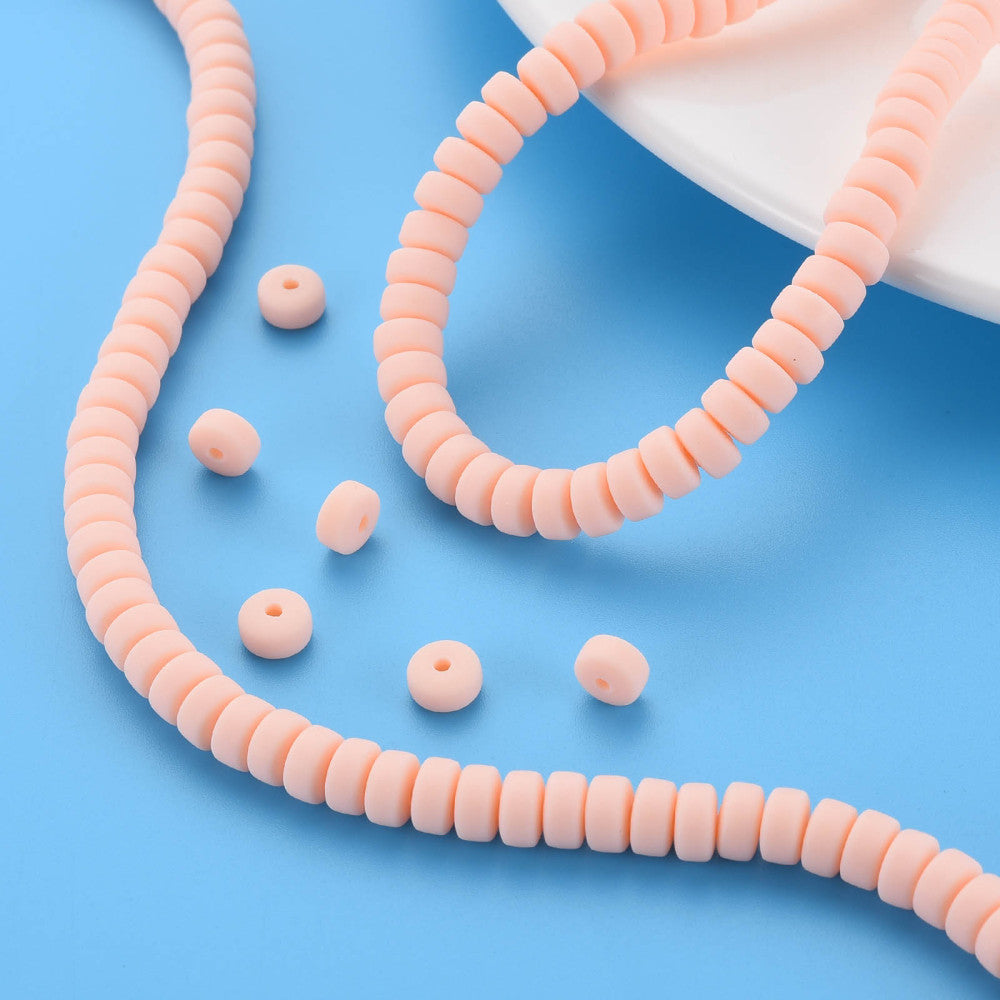 Flat round bead strand in pale pink with matching loose beads
