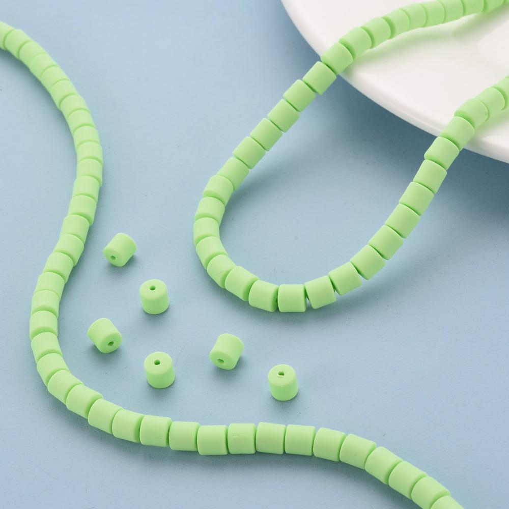 Pale green polymer clay column bead strand with matching beads scattered nearby