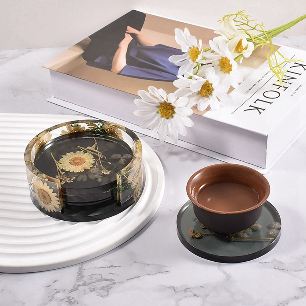 Round silicone coaster molds with dark resin inserts and flower decorations