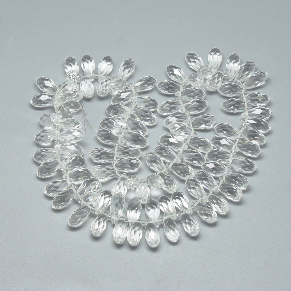 Clear faceted teardrop glass beads strand, arranged in a loop