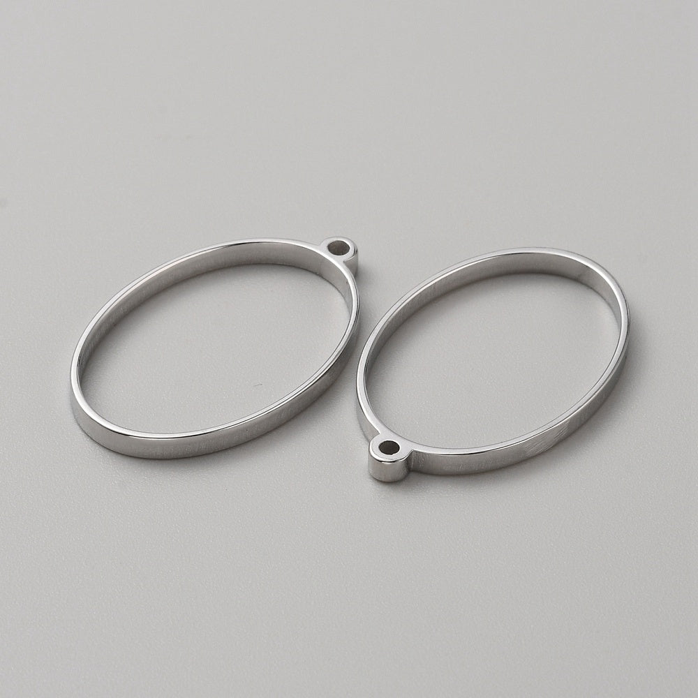 Two stainless steel oval open-back bezel pendants with top hanging loops