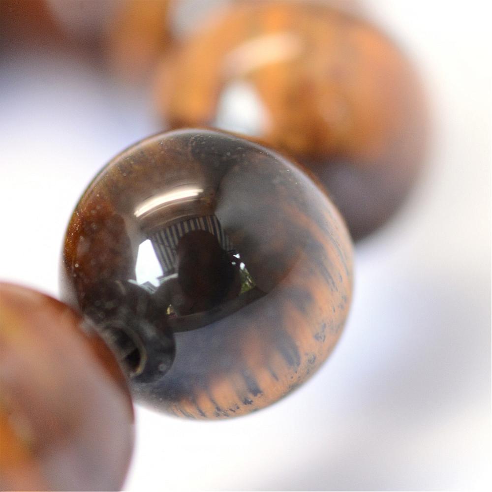 Single round tiger eye gemstone bead with reflective eye pattern, brown-gold