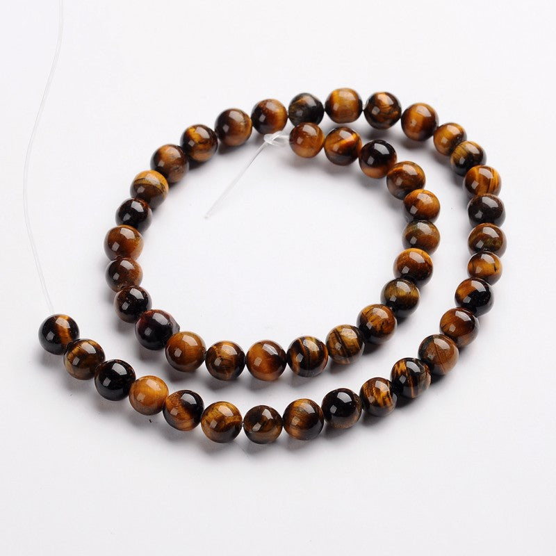 Tiger eye bead strand with round brown and amber stones, on string
