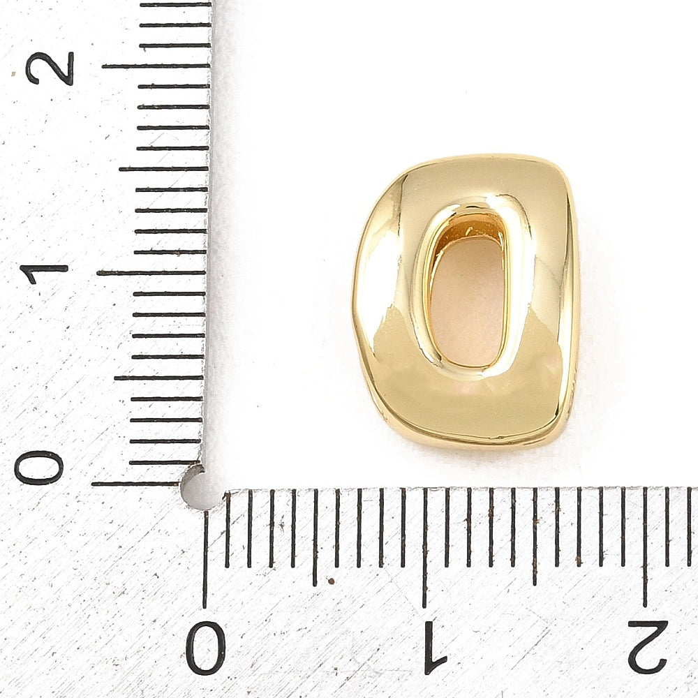 Gold-plated brass letter D slide bead beside ruler for size reference