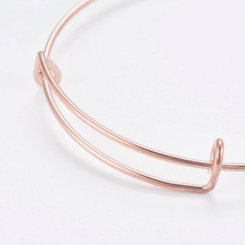 Rose gold alloy bangle bracelet, 65mm, double-arc design with end loop clasps