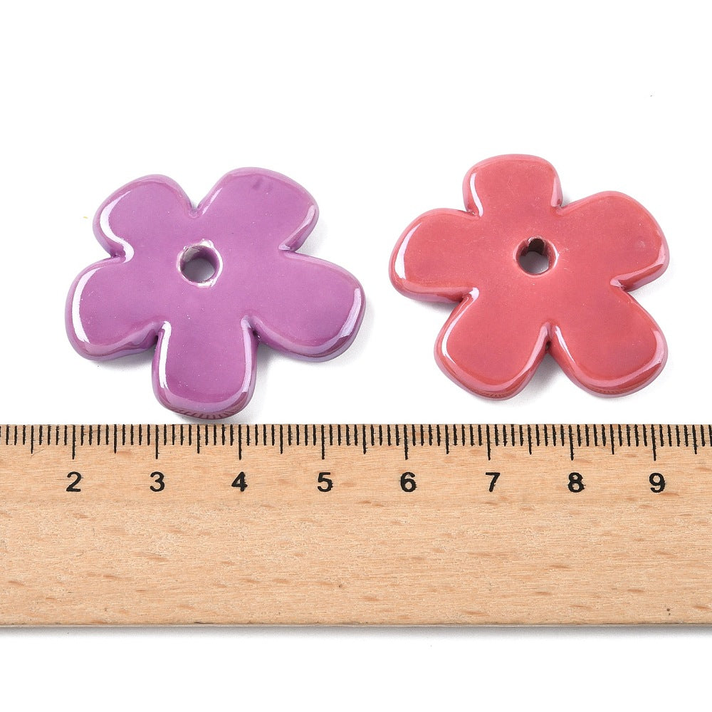 Porcelain flower beads, lavender and coral with central hole; size shown by ruler.