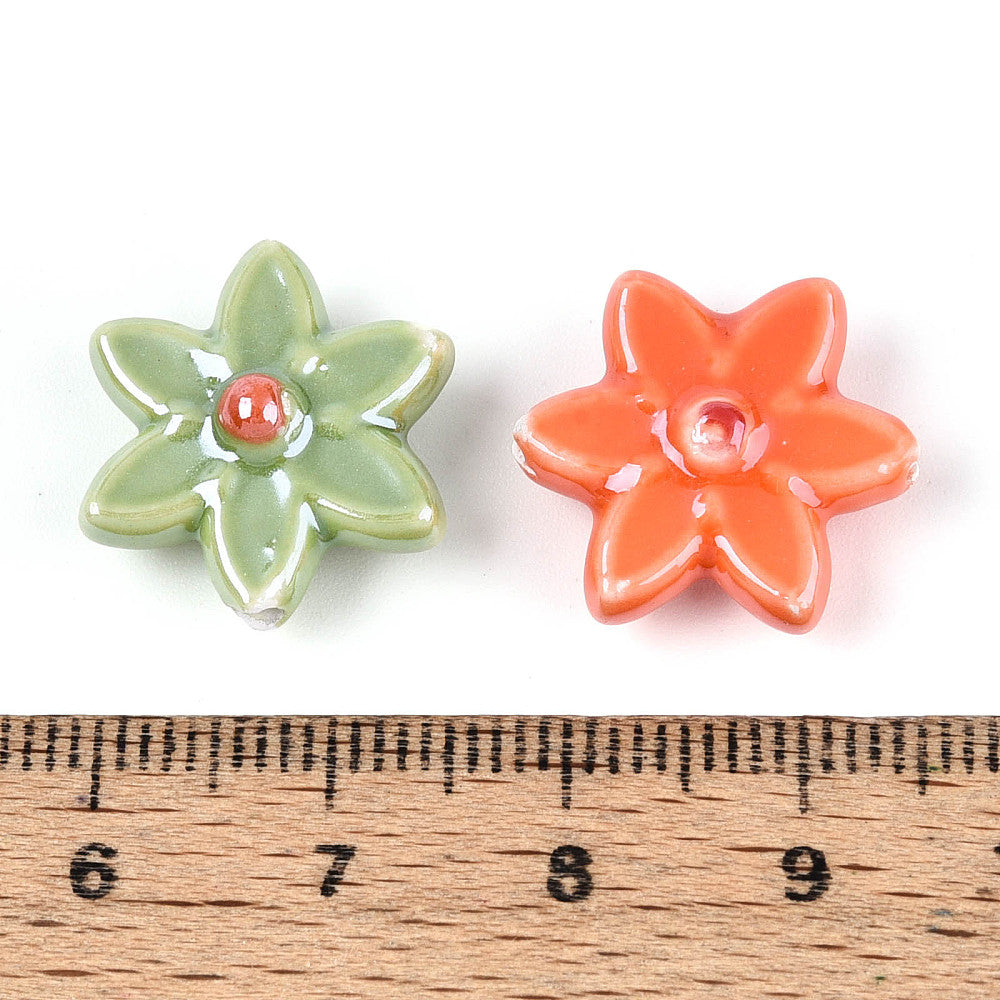 Porcelain flower beads in green and orange with red center dot, shown with ruler scale