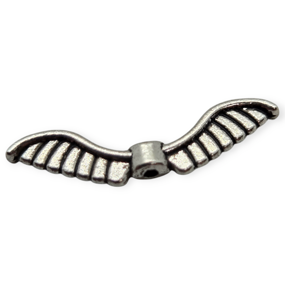 Wing-shaped metal bead with etched stripes and central hole