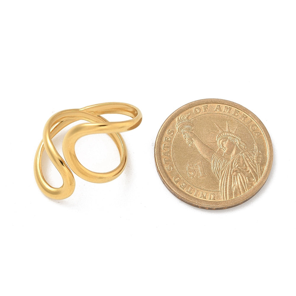 Gold-plated open cuff ring next to coin for scale, intertwined loops