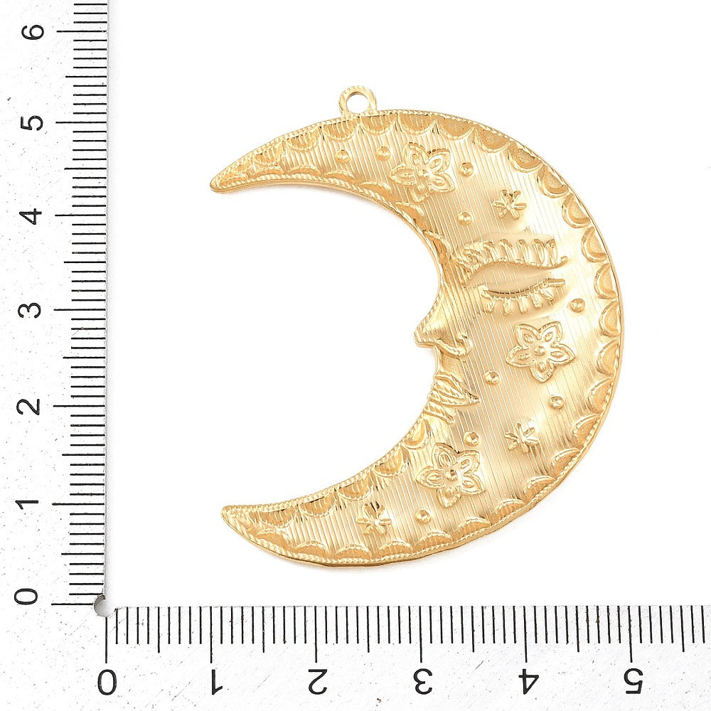 Gold-tone crescent moon charm pendant with floral and star engravings, with loop