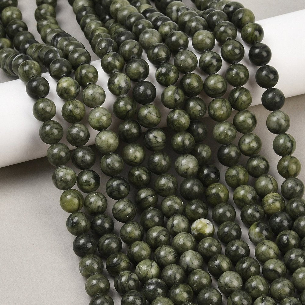 Multiple strands of round olive green jade beads with mottled green and dark tones