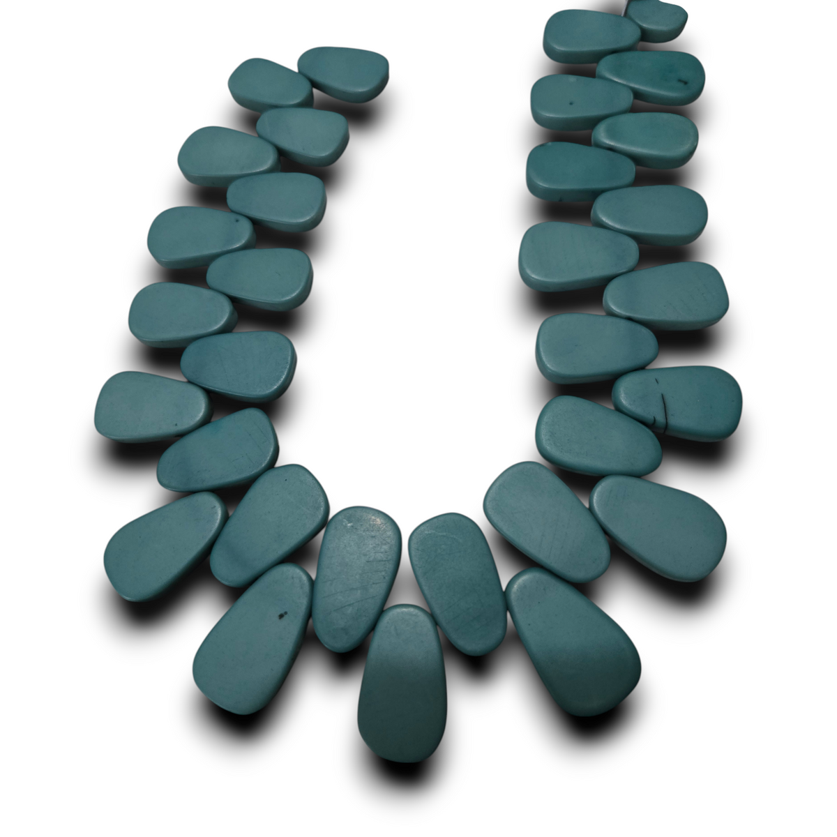 Turquoise flat teardrop resin bead strand with teal oval teardrop beads