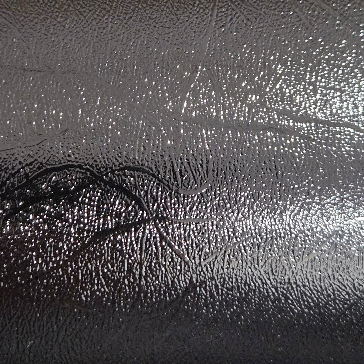 Glossy black textured permanent vinyl sheet with embossed leather-like pattern