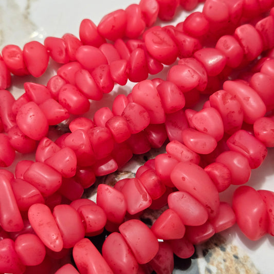 Pink resin chip bead strand with faceted irregular pieces