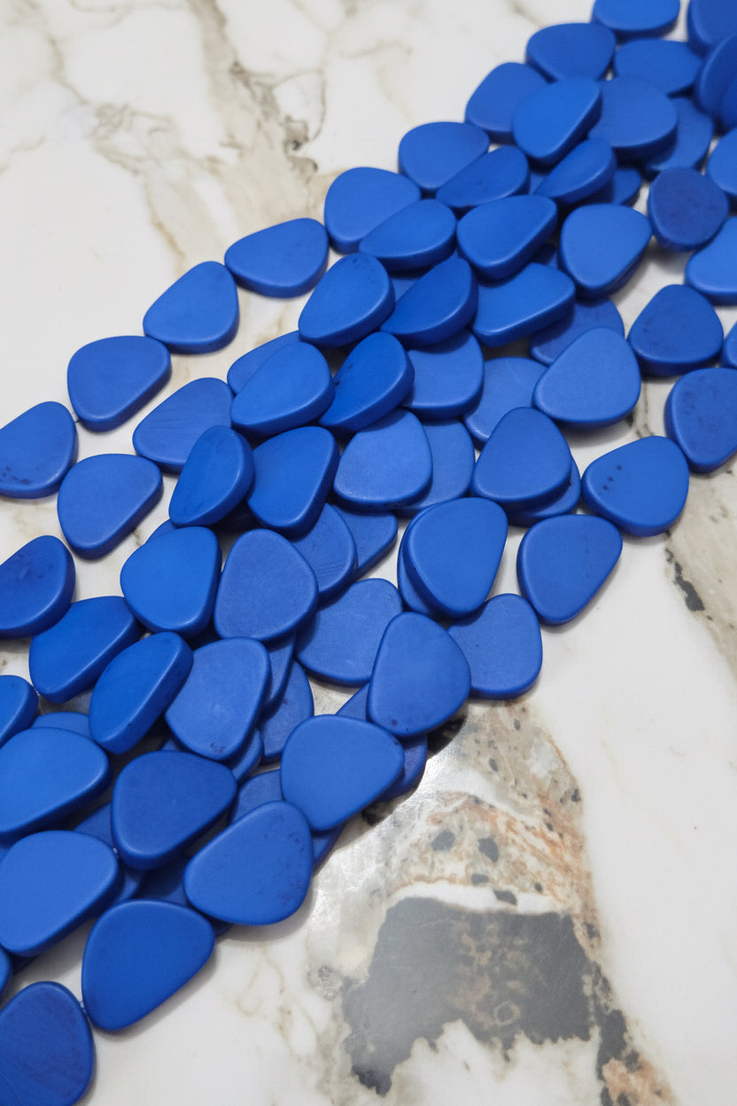 Blue triangle resin beads, scattered