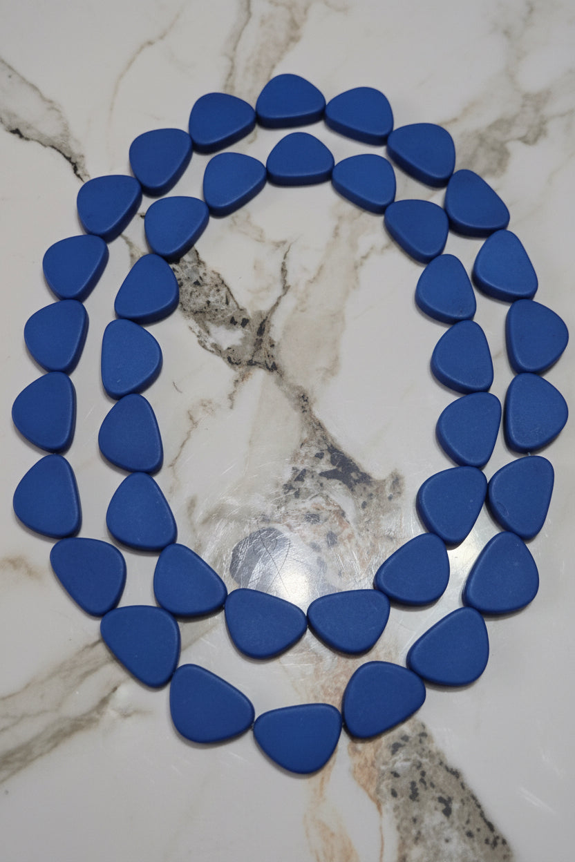 Blue triangle resin beads arranged in a circle