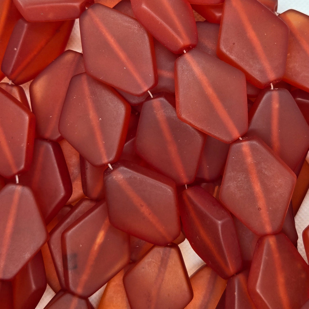 Orange flat diamond resin beads, close-up texture, matte finish