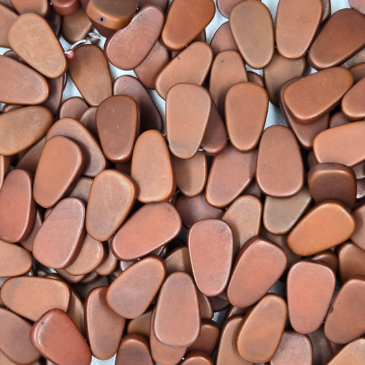 Brown teardrop resin beads, tightly packed, glossy finish