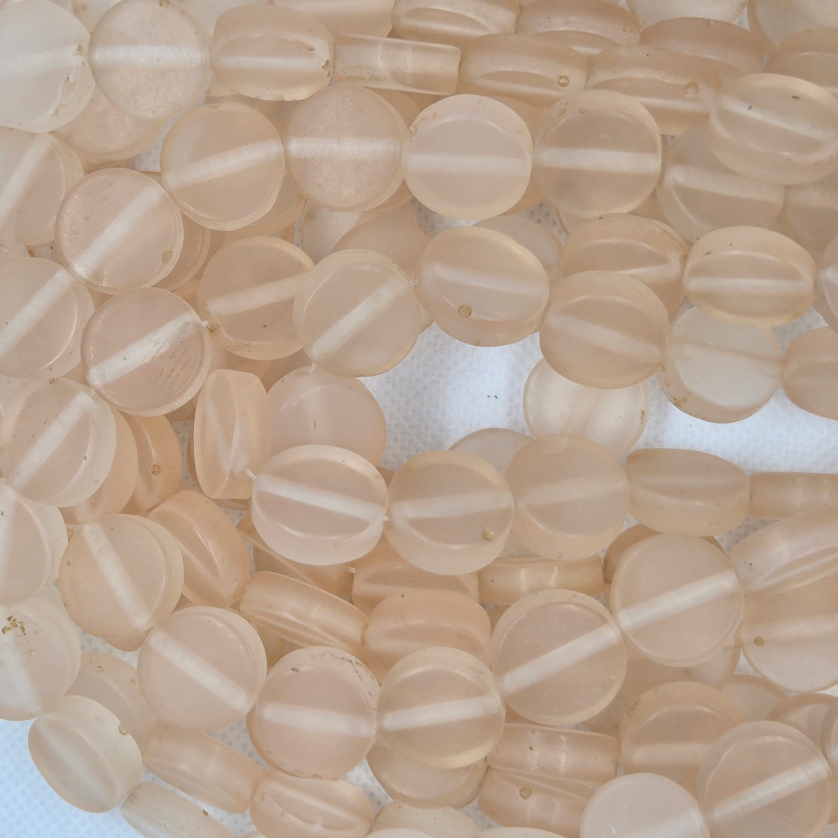 Clear flat round resin beads, translucent with center holes