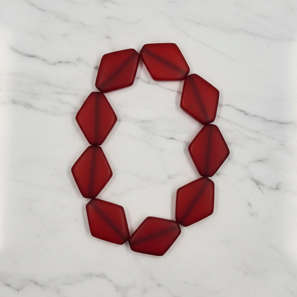 Diamond-shaped resin beads strand, deep red facets arranged in a loop