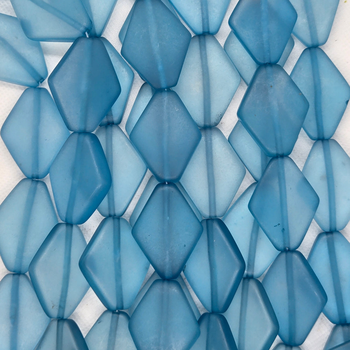 Sky blue diamond-shaped resin beads, close-up