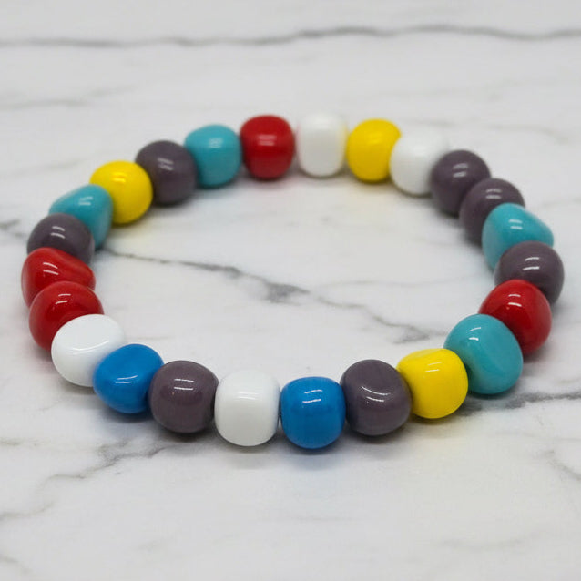 Single strand of round resin beads, multicolor with blue, red, yellow, and white.