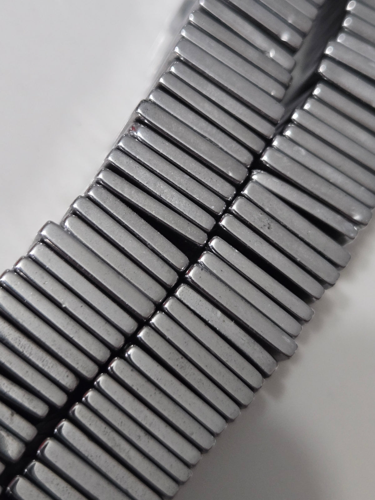 Hematite square link detail with silver bars and dark facets