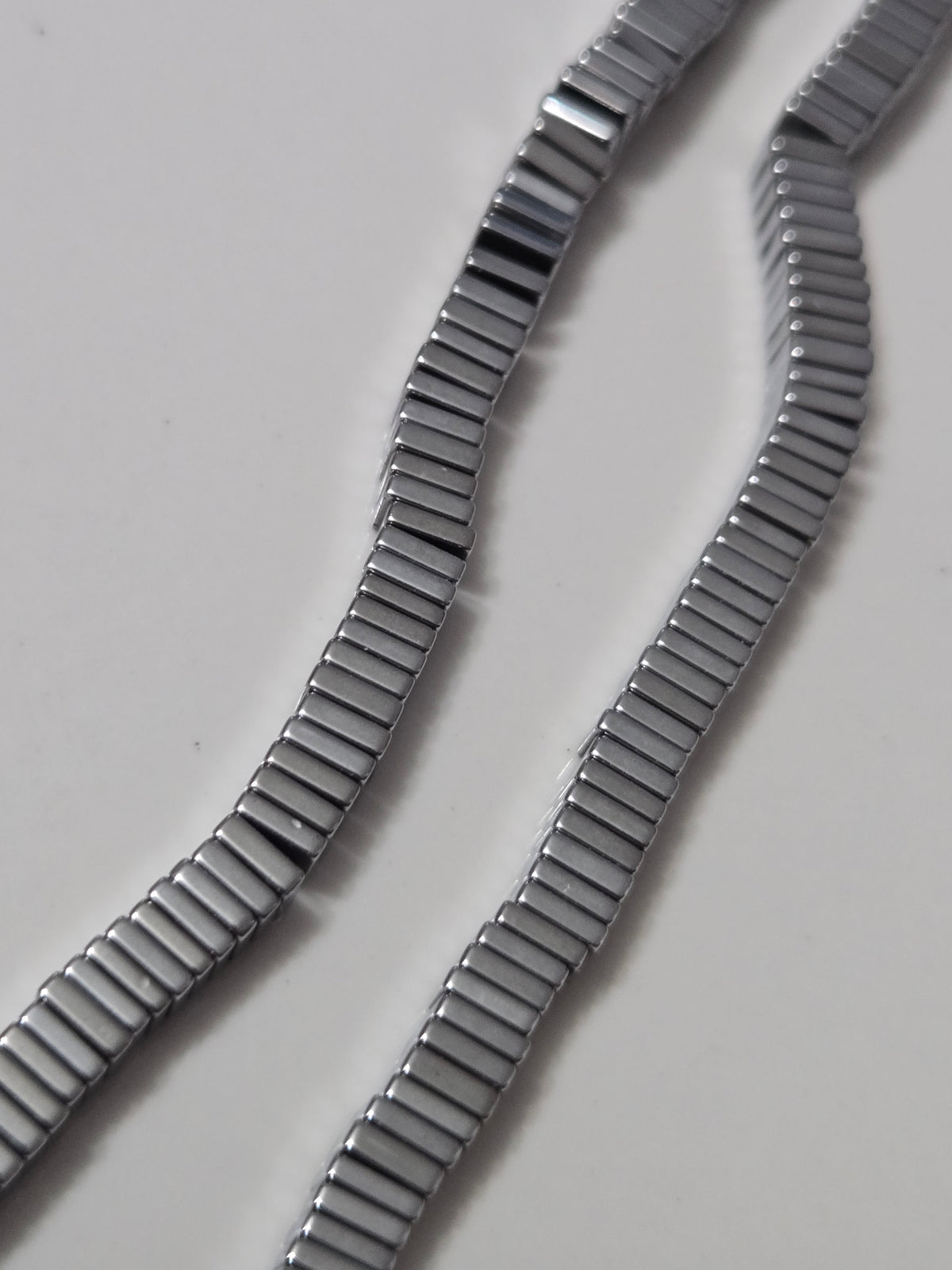 Silver hematite square bead bracelet strands with dark ribbed metallic texture