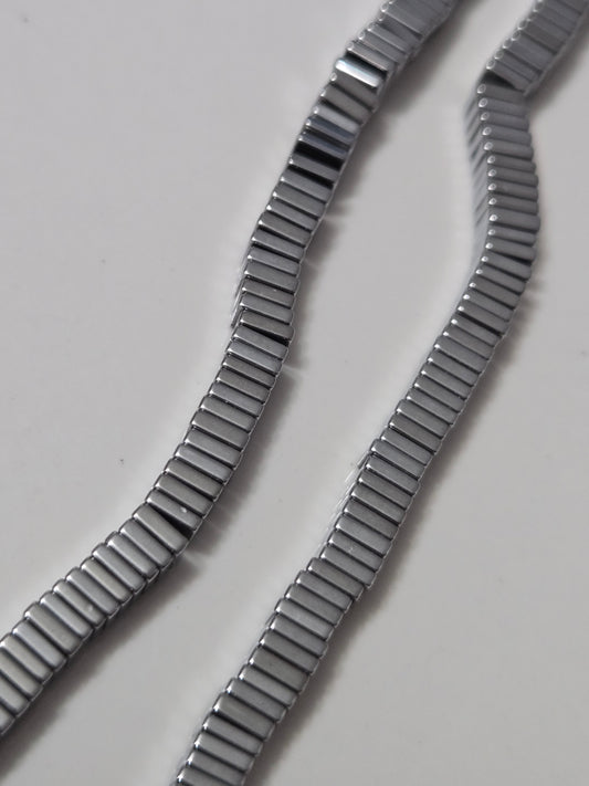 Silver hematite square bead bracelet strands with dark ribbed metallic texture
