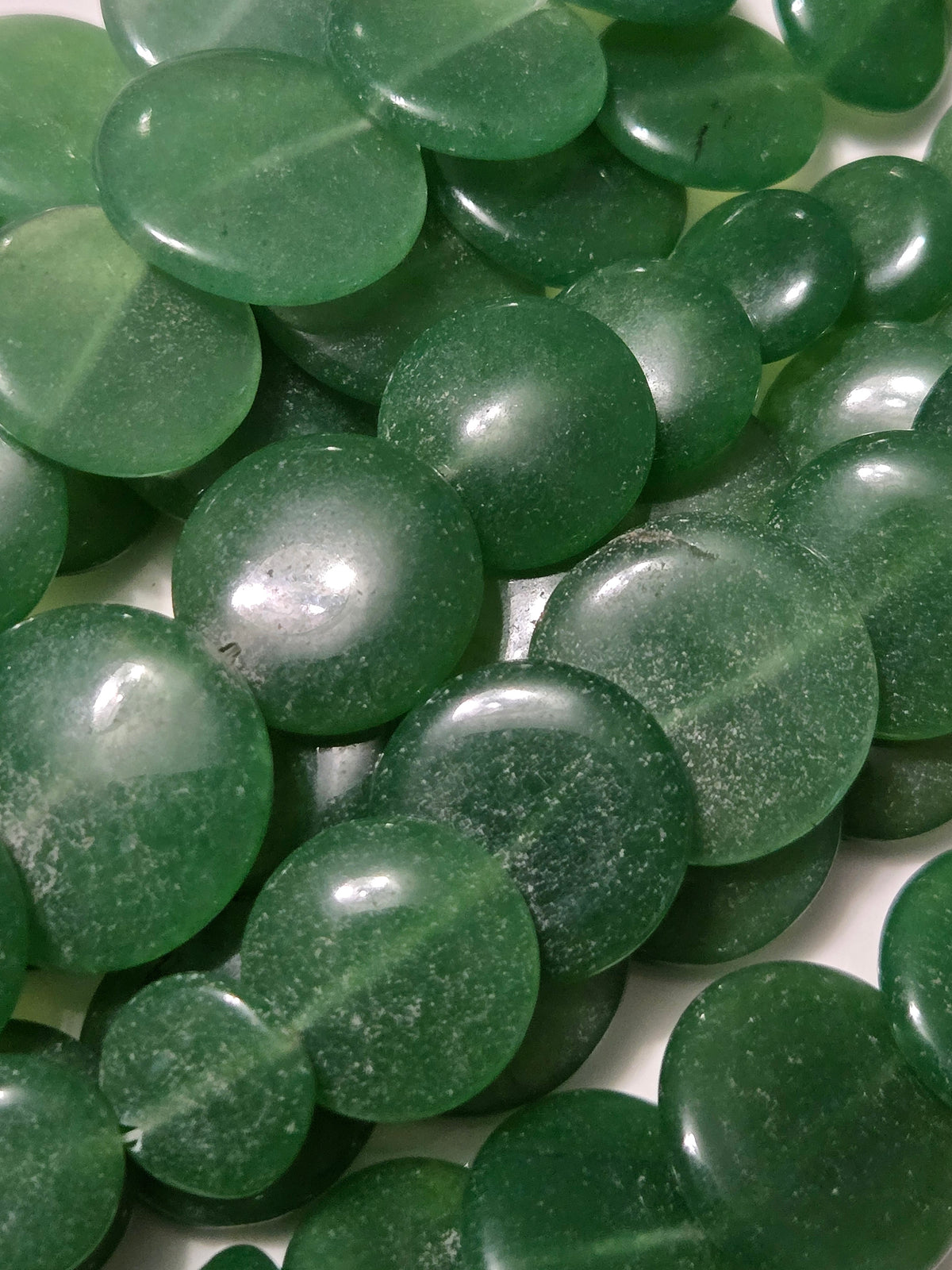 Green jade irregular oval stones, glossy surface.