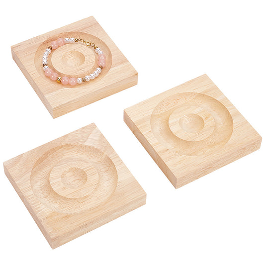 Set of three wood jewelry display trays with circular swirl carved medallions