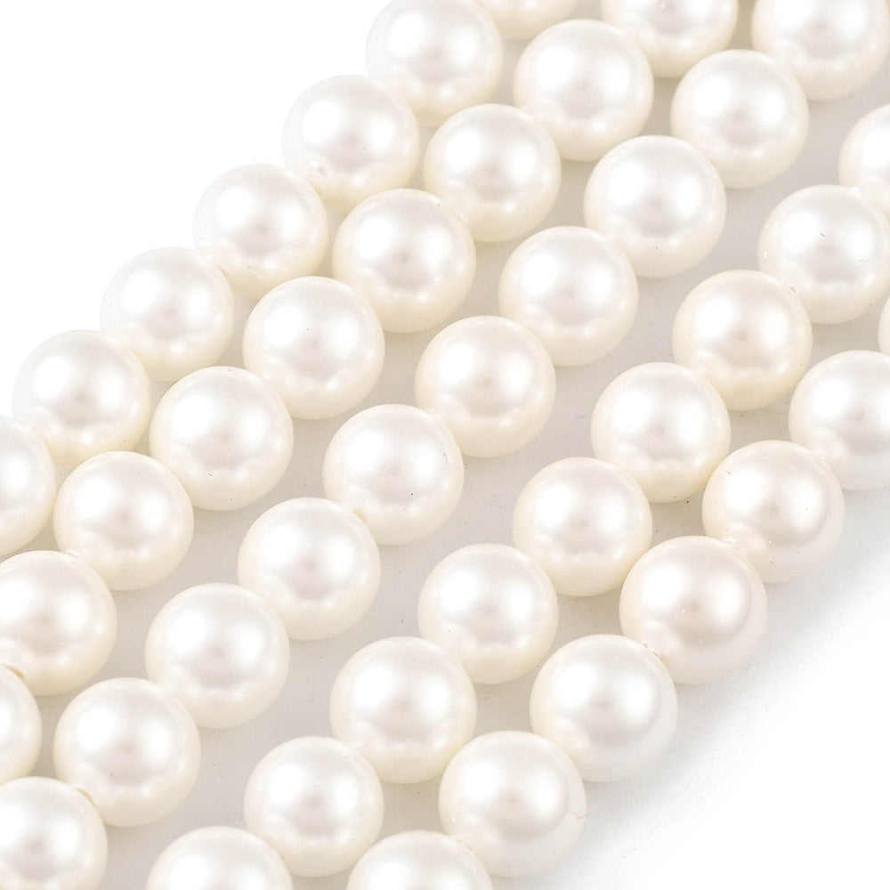 White round pearl beads close-up, smooth glossy surface