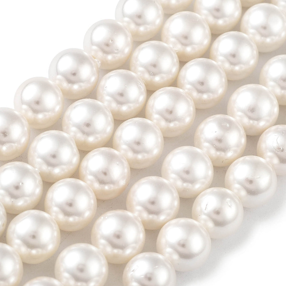 Round white pearl beads strand with glossy surface detail, tightly grouped