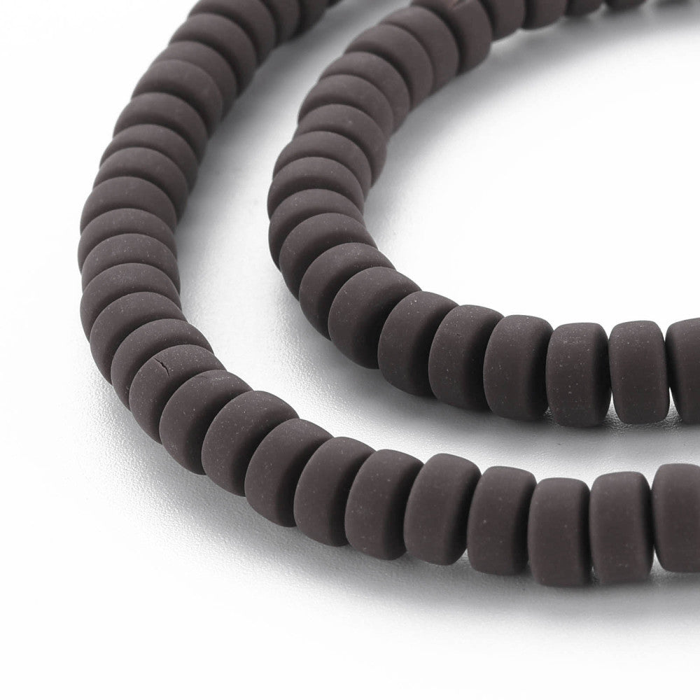 Close-up of flat round dark brown beads with central drilled holes
