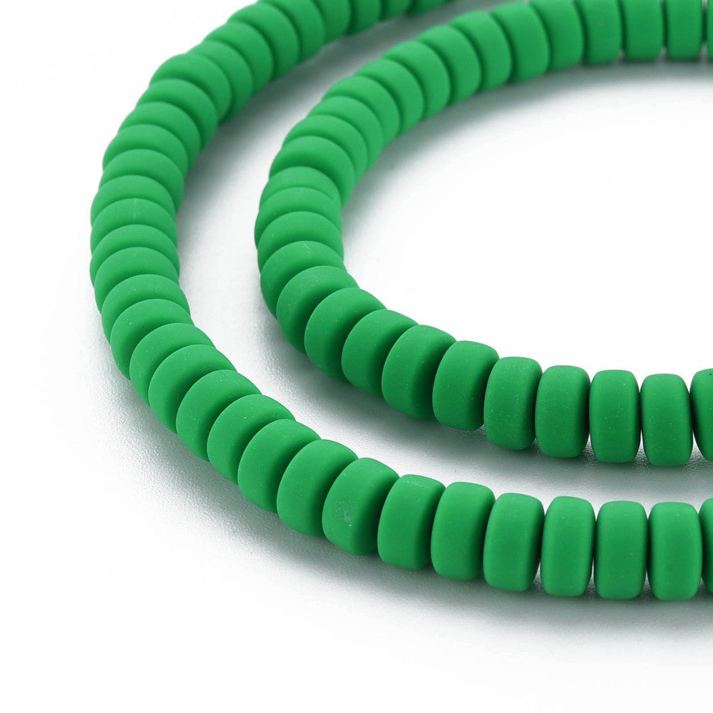 Green flat round bead strand, side view showing stacked ridged discs