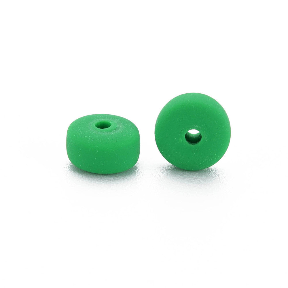 Two green flat round polymer clay beads with center holes