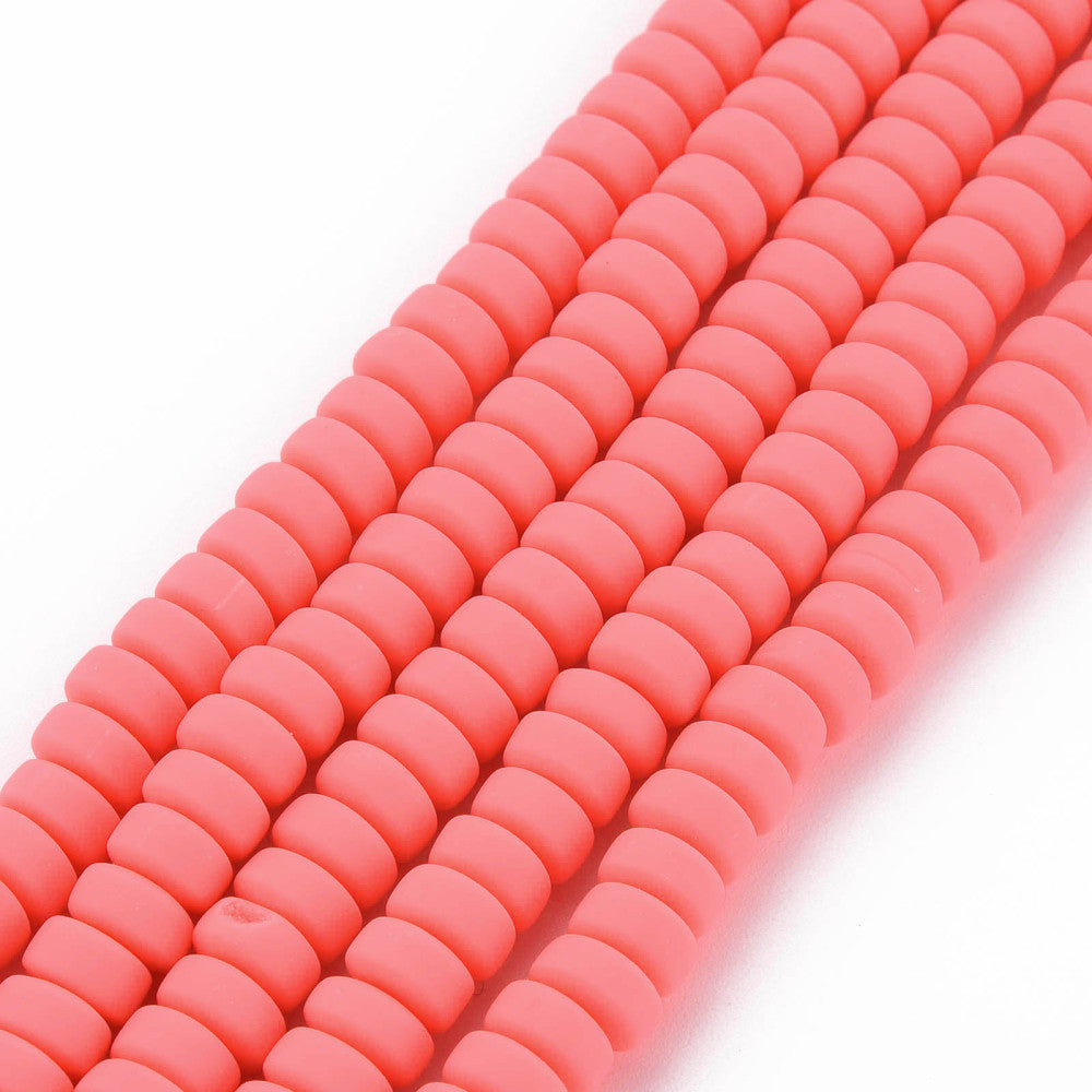 Flat round polymer clay bead strand in tomato red, close-up of linked disc beads