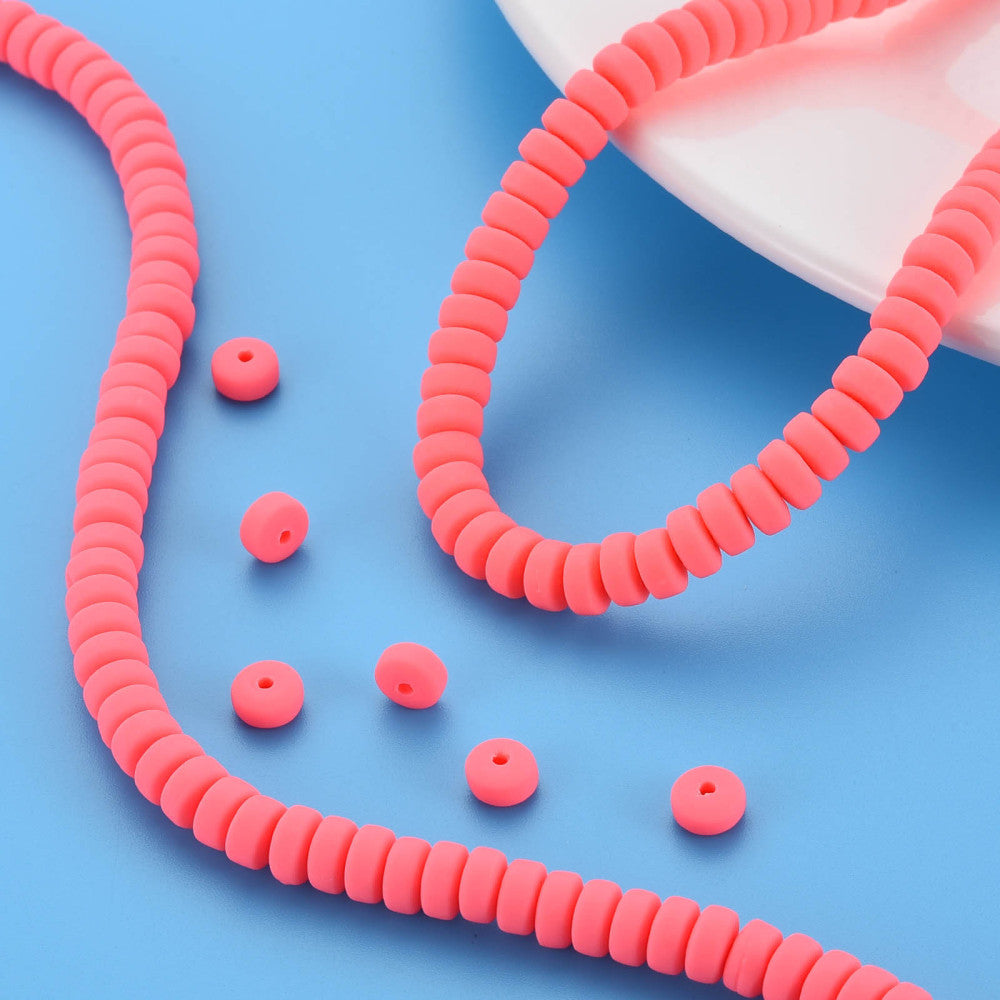 Flat round polymer clay bead strand with loose matching beads in tomato red