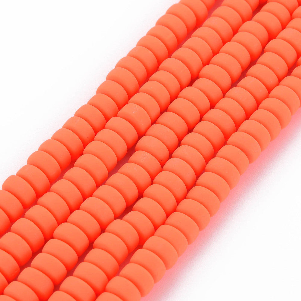 Orange-red flat round polymer clay bead strand, ridged disc beads, angled view