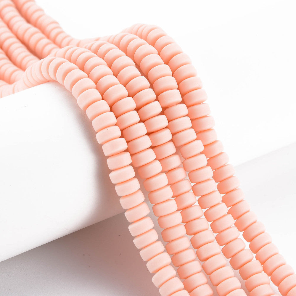 Flat round bead strand in pale pink, ridged barrel disks