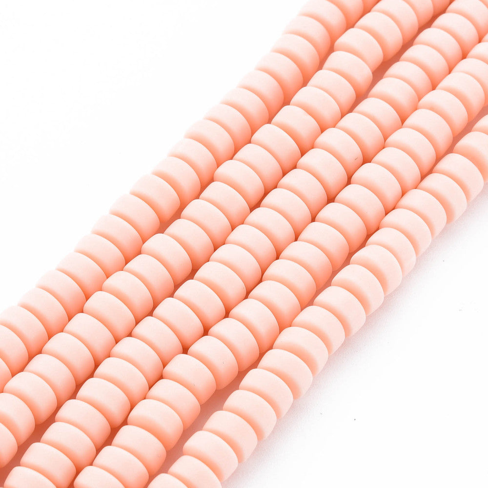 Flat round bead strand in pale pink, closely spaced ridged discs