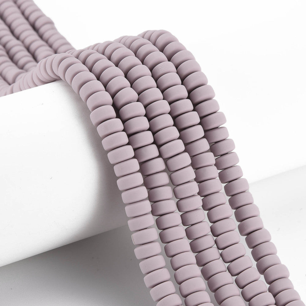 Polymer clay flat round bead strand in lavender-pink, stacked close-up