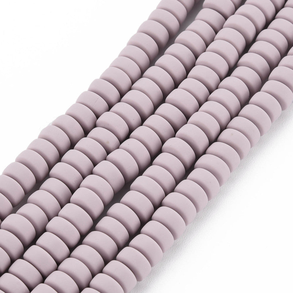 Polymer clay flat round bead strand, curved close-up of lavender-pink beads