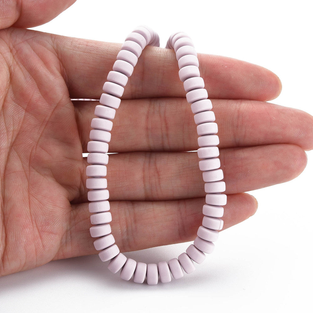 Polymer clay bead strand on hand, flat round lavender-pink beads with holes
