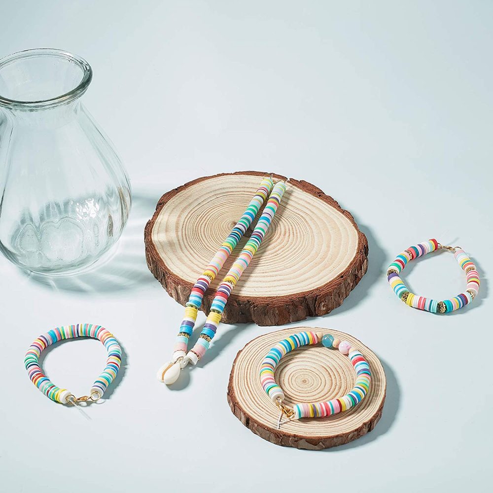 Multicolor heishi bead bracelets on wood slices, flat disc beads with holes