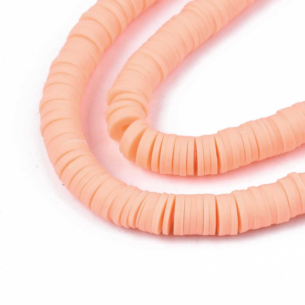 Light salmon heishi disc beads strand in close curve view, small round holes