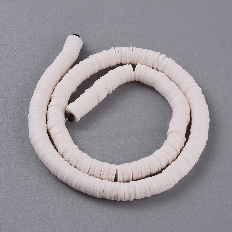 Misty rose heishi disc bead strand with smooth round polymer clay beads, coiled.