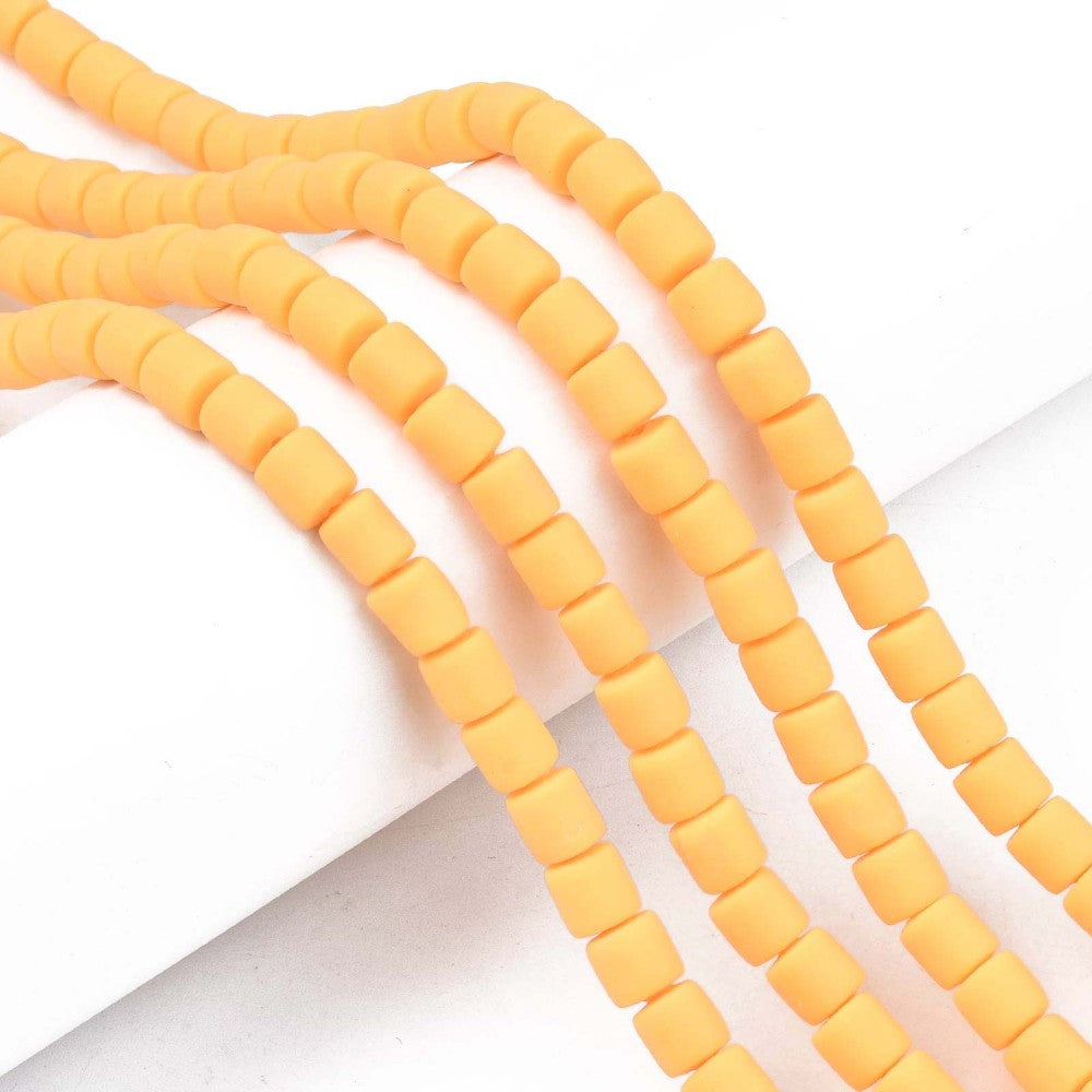Orange polymer clay bead strand with 6mm tube beads, spaced in rows