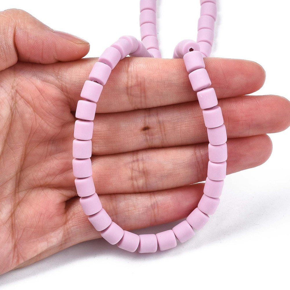 Light purple polymer clay column bead bracelet held in a hand